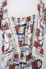 Women's vintage 1980's Lane Bryant label flutter sleeve blouse with cream lace trim and a square neckline. All over multicolored patchwork print.