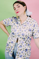 Women's vintage 1980's LORI by AM Casuals short sleeve button up blouse in white with all over blue floral print. Stretchy polyester material.