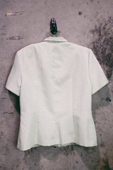 Women's vintage 1990's Sweet Suit label short sleeve button up blazer with double lapel and silver metal detail. In a light green and white all over checkered print.