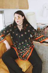 Women's vintage 1970's. Montgomery Ward label long sleeve black tunic blouse with a tie front neck and triangle shaped hem.