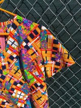 Women's vintage 1970's short sleeve mini length multicolored shift dress in polyester with v shaped neckline.