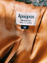 Women's vintage 1960's Apropos, Made in Korea label long sleeve knee length genuine fur coat with burnt orange leather trim and a tie belt.