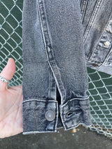 Women's Levi's black grey wash long sleeve button up lightweight jacket with brass hardware and pockets.