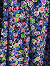 Women's vintage 1970's short sleeve maxi dress with a blue top and a multicolored printed skirt in polyester.