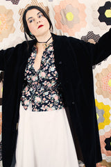 Women's vintage 1950's "365" by All-State label long sleeve knee length black velvet duster jacket with button front closure and pink satin liner.