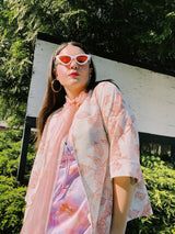 Women's vintage 1970's open front silver metallic blouse with short sleeves and all over white and pink rose floral print.