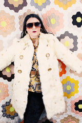 Women's vintage 1960's long sleeve genuine fur pea coat with a double breasted closure. Cream colored with all over brown speckles.