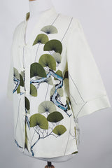 Women's vintage 1970's Tori Richard, Honolulu label cream colored long sleeve tunic blouse with floral print in the front and fabric buttons up the front.