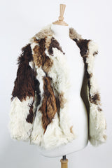 Women's vintage 1970's long sleeve genuine fur coat with double lapel in white with black and white patchwork details.