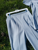 Women's vintage 1970's matching pant set with pants and button up shirt blouse in blue and white gingham polyester material.