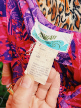 Women's vintage 1970's Penneys Hawaii label short sleeve maxi length dress with an all over pink and purple Hawaiian print.