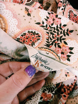 Women's vintage 1970's Stephanie, K by Koret label long sleeve button up blouse with small dagger collar in tan color and all over pale pink paisley print.