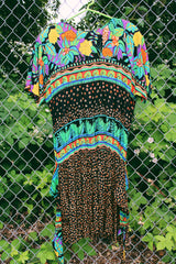 Women's vintage 1980's Carol Little label short sleeve midi length Summer dress with tropical floral print. Has a beaded wrap tie detail in the front.