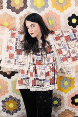 Women's vintage 1980's Lane Bryant label flutter sleeve blouse with cream lace trim and a square neckline. All over multicolored patchwork print.