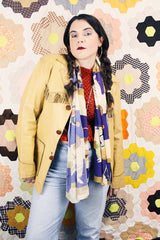 Men's or women's vintage 1950's long sleeve light tan colored genuine leather jacket with button front closure and fringe trim in front and back.