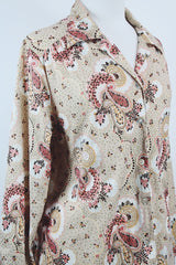 Women's vintage 1970's Stephanie, K by Koret label long sleeve button up blouse with small dagger collar in tan color and all over pale pink paisley print.