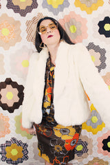 Women's vintage 1970's Wilsons Suede & Leather, Made in Korea label long sleeve bright white genuine fur coat with one hook and eye closure in the front.