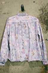 Women's vintage 1970's long sleeve button up blouse in an all over purple, blue, and pink floral print. Two chest pockets.