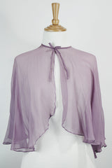 Women's vintage 1980's sheer silk material cape blouse in a light purple color. Has one hook and eye closure at neck with attached bow.
