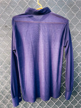 Women's or men's vintage 1970's long sleeve navy blue t-shirt with a paisley print on the front, a rounded dagger collar, and white popper buttons.