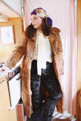 Women's vintage 1960's Apropos, Made in Korea label long sleeve knee length genuine fur coat with burnt orange leather trim and a tie belt.