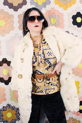 Women's vintage 1960's long sleeve genuine fur pea coat with a double breasted closure. Cream colored with all over brown speckles.