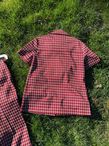 Women's vintage 1970's matching pant set with pants and a short sleeve button up shirt in maroon and white checkered print.