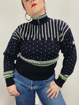 Women's vintage 1980's Demetre label long sleeve black pullover ski sweater with a half zip closure and white and green print all over.