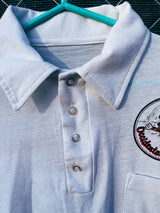 Women's or men's vintage 1970's short sleeve white polo t-shirt with half button closure and a graphic on the front left chest and one in the back.