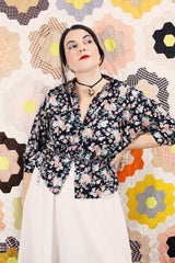 Women's vintage 1970's Ship N' Shore label short sleeve all over ditsy floral print blouse that buttons up the front and cinches at the waist.