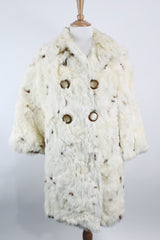 Women's vintage 1960's long sleeve genuine fur pea coat with a double breasted closure. Cream colored with all over brown speckles.