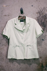 Women's vintage 1990's Sweet Suit label short sleeve button up blazer with double lapel and silver metal detail. In a light green and white all over checkered print.