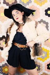 Women's vintage 1970's long sleeve genuine fur coat with double lapel in white with black and white patchwork details.