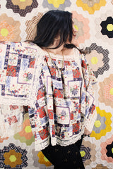 Women's vintage 1980's Lane Bryant label flutter sleeve blouse with cream lace trim and a square neckline. All over multicolored patchwork print.