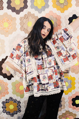 Women's vintage 1980's Lane Bryant label flutter sleeve blouse with cream lace trim and a square neckline. All over multicolored patchwork print.