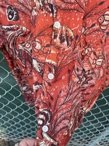 Men's vintage 1950's/1960's Leonardo label short sleeve button up rayon shirt in brown color with all over fish and seashell print.