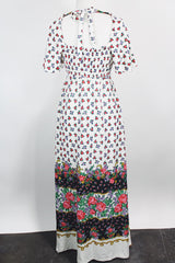 Women's vintage 1970's maxi length dress with flutter sleeves in white. Has an all over red and black ditsy floral print.