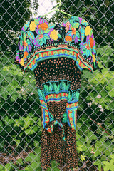 Women's vintage 1980's Carol Little label short sleeve midi length Summer dress with tropical floral print. Has a beaded wrap tie detail in the front.