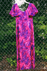 Women's vintage 1970's Penneys Hawaii label short sleeve maxi length dress with an all over pink and purple Hawaiian print.