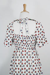 Women's vintage 1970's maxi length dress with flutter sleeves in white. Has an all over red and black ditsy floral print.