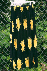 Women's vintage 1990's Anthony Mark Hankins label midi length black skirt with all over bright yellow flower. Tight pleats throughout with a stretchy elastic waistband.