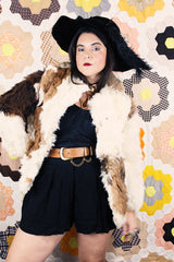 Women's vintage 1970's long sleeve genuine fur coat with double lapel in white with black and white patchwork details.