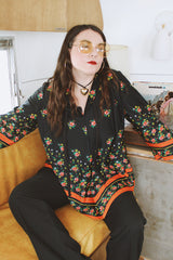 Women's vintage 1970's. Montgomery Ward label long sleeve black tunic blouse with a tie front neck and triangle shaped hem.