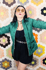 Women's vintage 1960's reversible long sleeve satin smoking jacket. Green on one side and cream on the other. Fabric buttons.