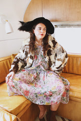 Women's vintage 1970's long sleeve multicolored patchwork genuine fur coat with hook and eye closures in the front. Grey, brown, cream, and black colors