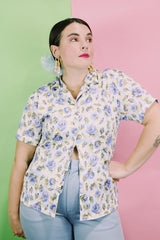 Women's vintage 1980's LORI by AM Casuals short sleeve button up blouse in white with all over blue floral print. Stretchy polyester material.