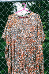 Women's vintage 1970's short sleeve maxi length muu muu kaftan dress in an all over leopard print in a polyester material.
