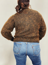 Women's vintage 1980's long sleeve brown orange wool cardigan with brass buttons and two abstract patches in the front.