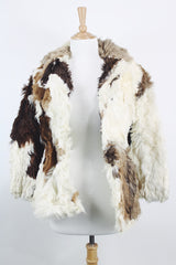Women's vintage 1970's long sleeve genuine fur coat with double lapel in white with black and white patchwork details.