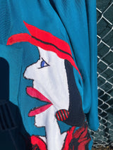 Women's vintage 1980's made in usa long sleeve blue blazer with one button closure and fully lined with large patches of people on front and back.